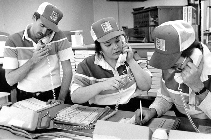 Domino's employees man the phones during the first half of the Super Bowl..;