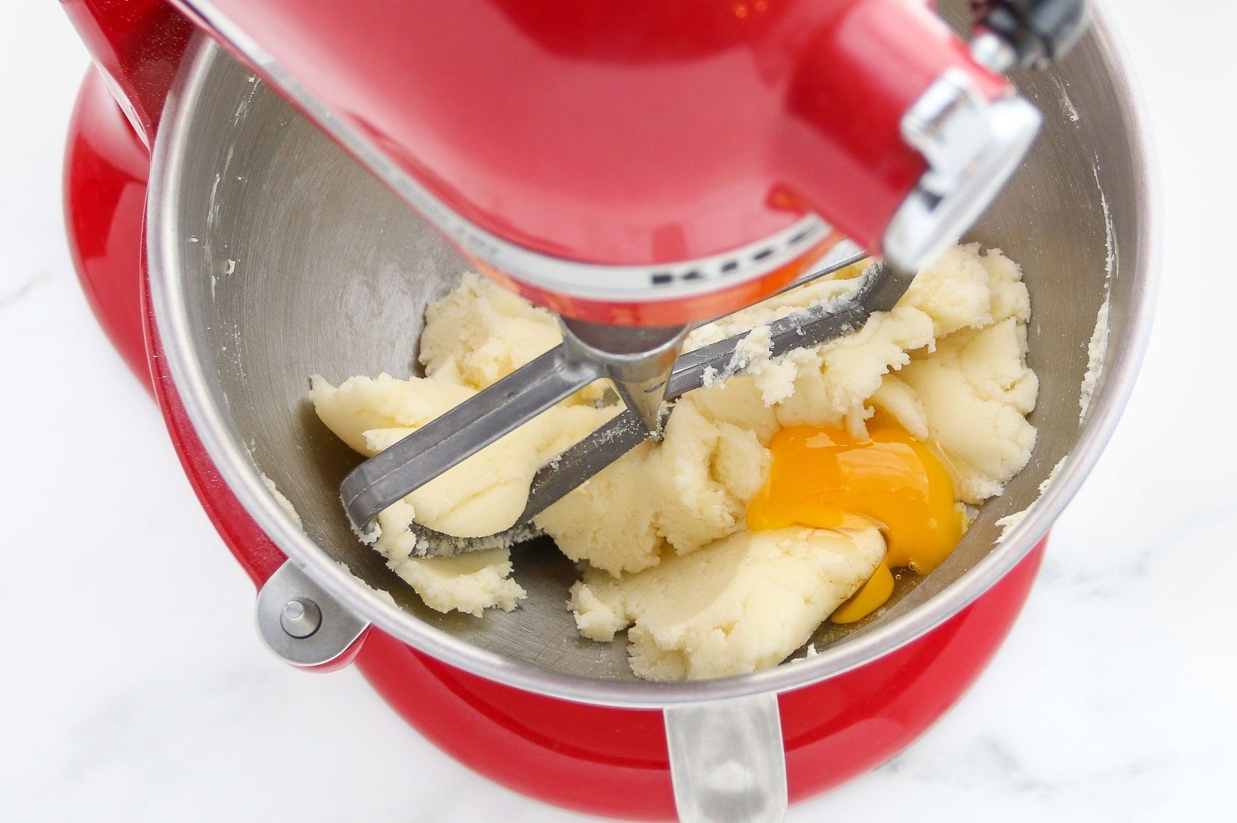 beating eggs with the fluffy butter in a stand up mixer