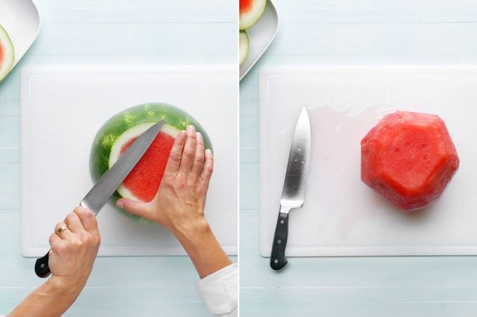 taking the rind off of the watermelon on a white cutting board
