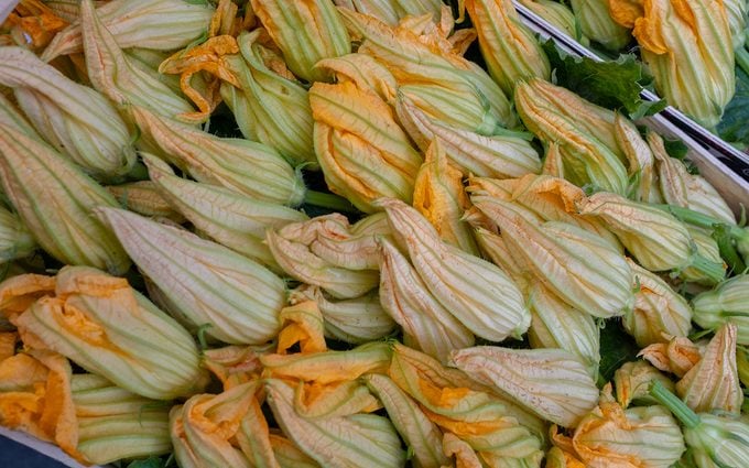 Zucchini flowers Naples, Italy October 23 2018 A box of fresh squash flowers in a local Italian market