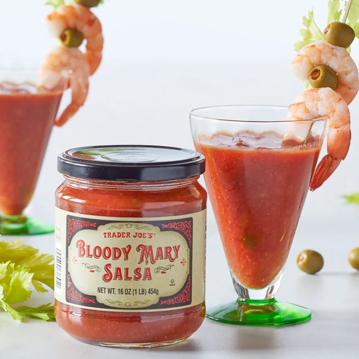 two cocktail glasses filled with Trader Joe's Bloody Mary Salsa, garnished with shrimp, olives and celery