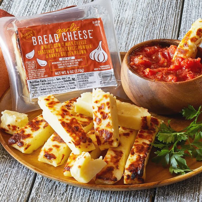 Trader Joe's Garlic Bread Cheese cut into strips and on platter, with a dish of bruschetta for dipping