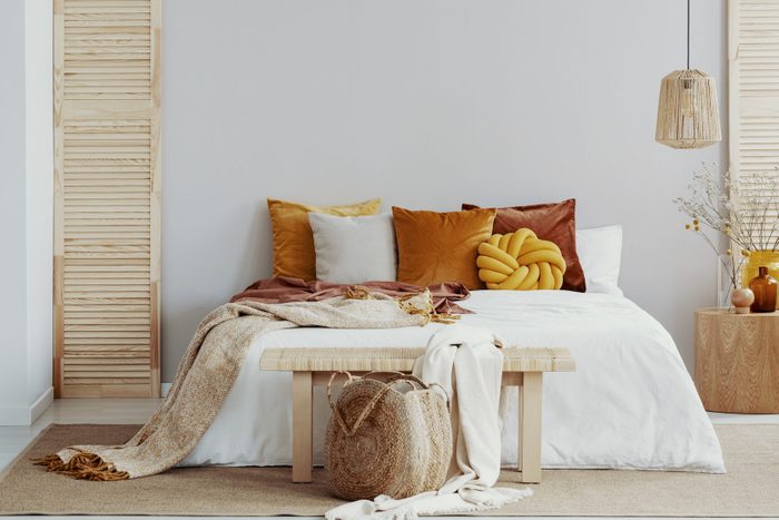 ochre color scheme throw pillows on bed