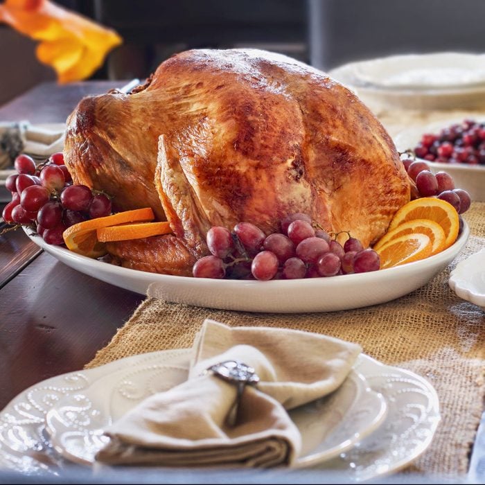 Thanksgiving Day table set with Roasted Prepared Turkey