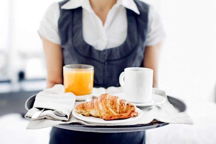 Room Service Hotel Staff Carries Breakfast Tray