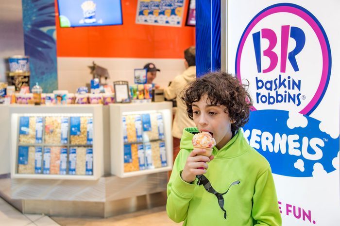 Baskin Robins, Hispanic boy eating delicious ice cream in...
