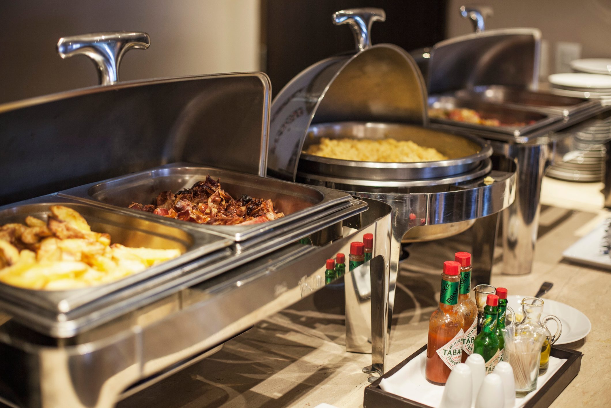 Prepared Food In Warming Dishes On Buffet at a hotel