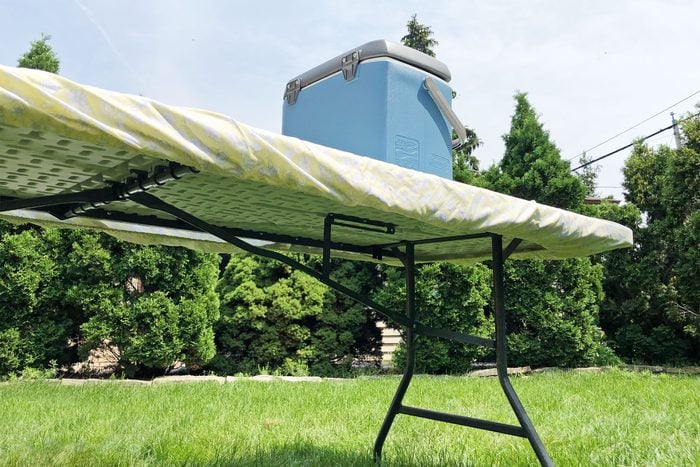 twin fitted sheet tablecloth around an outdoor folding table