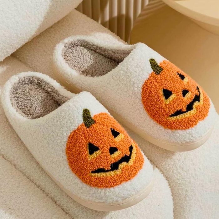 A Pair of Slippers With a Pumpkin Design