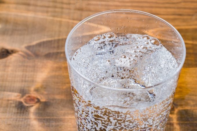 Carbonated water on wood grain background