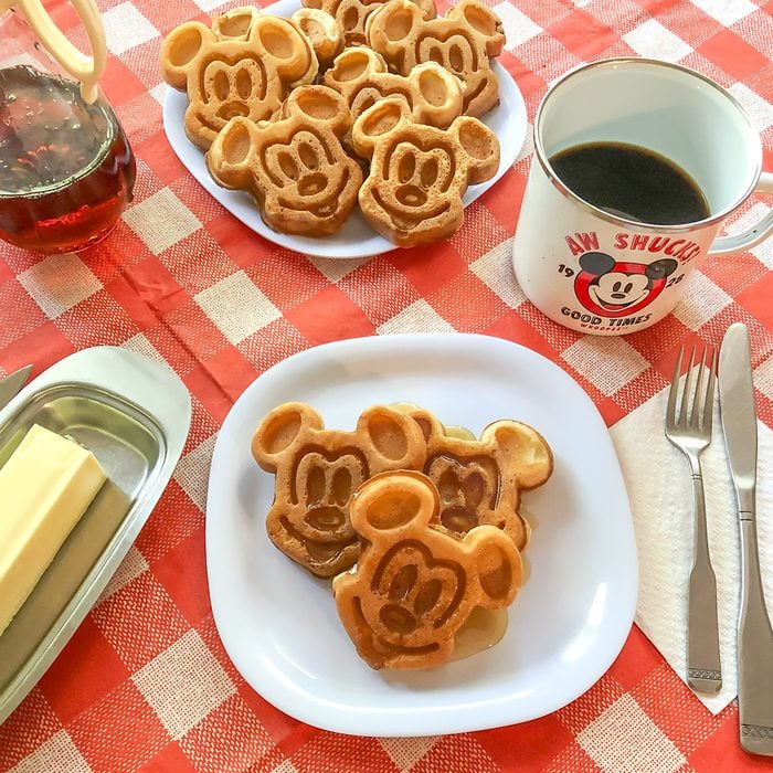 Mickey Waffles square with black coffee and butter on a breakfast table