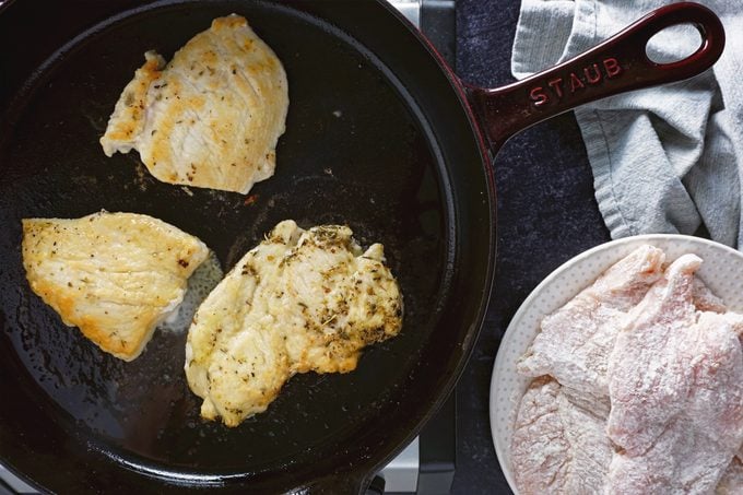 chicken cooking in pan