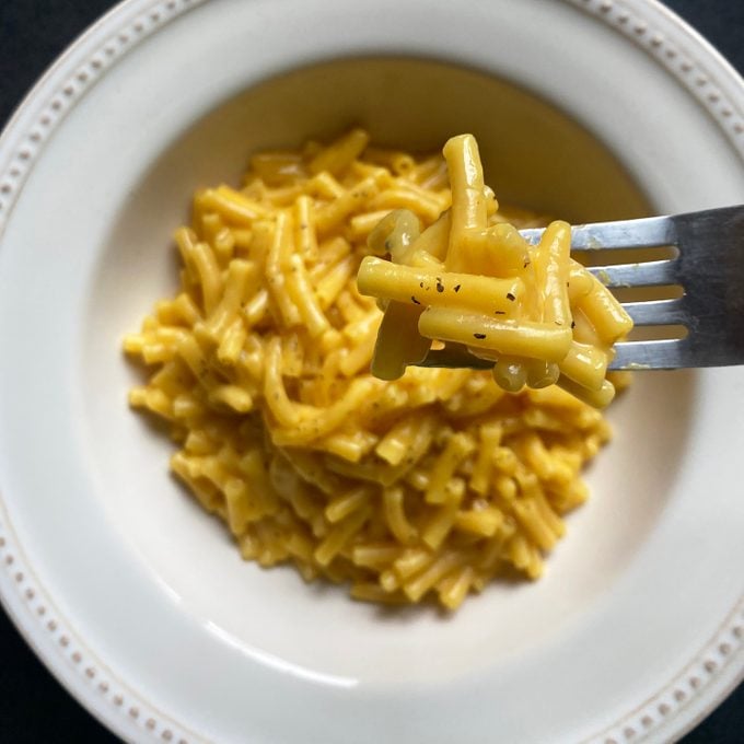 tiktok mac and cheese on fork over bowl