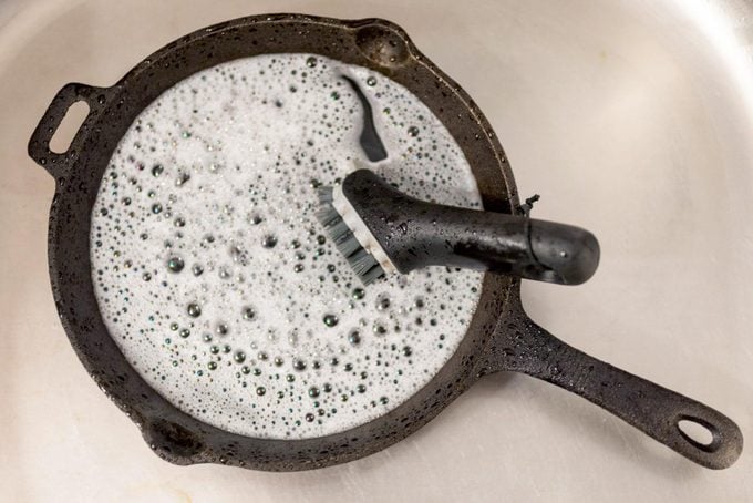 cast iron pan filled with soapy water