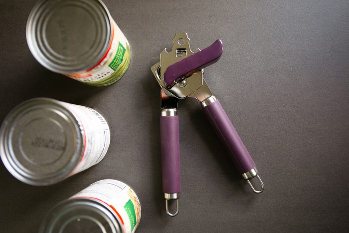 cans and a can opener to show how to use a can opener