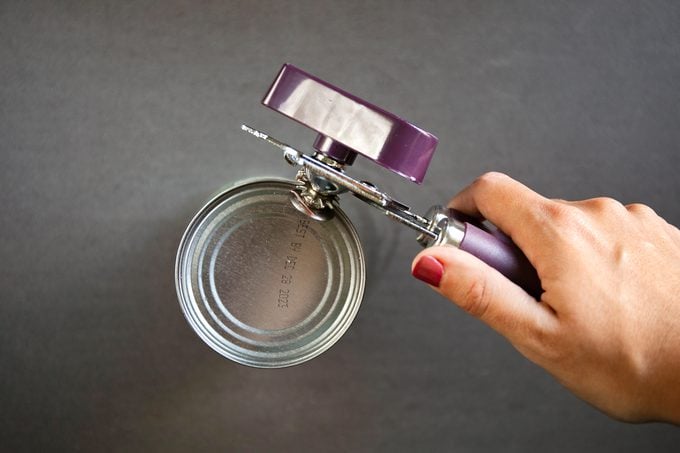 showing how to use a can opener from above the classic way