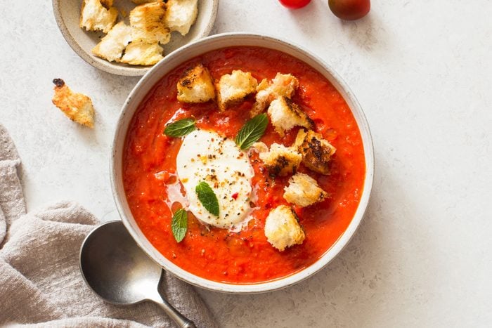 Bowl Of Tomato Soup With Mozzarella And Croutons On Gray Stone Background