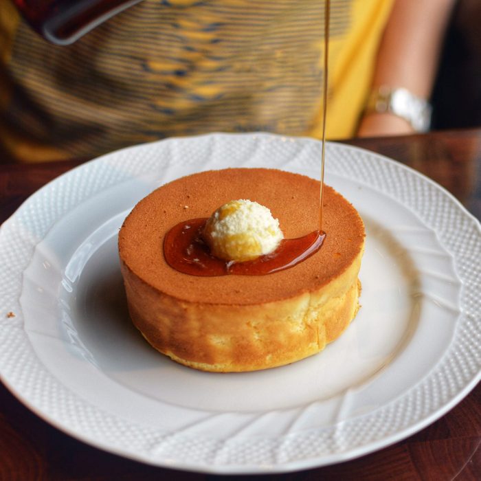 Pouring Maple Syrup On Souffle Pancake