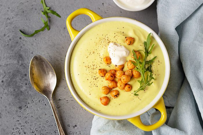 Creamy cauliflower curry soup with roasted chickpea and sour cream