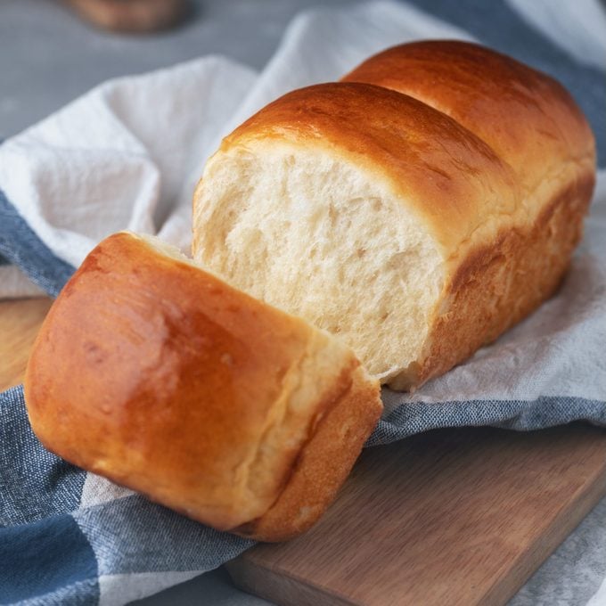 Fresh Baked Homemade Hokkaido Milk Bread On The Kitchen Towel. Japanese Soft And Fluffy Bread. Cooking At Home. Selective Focus.