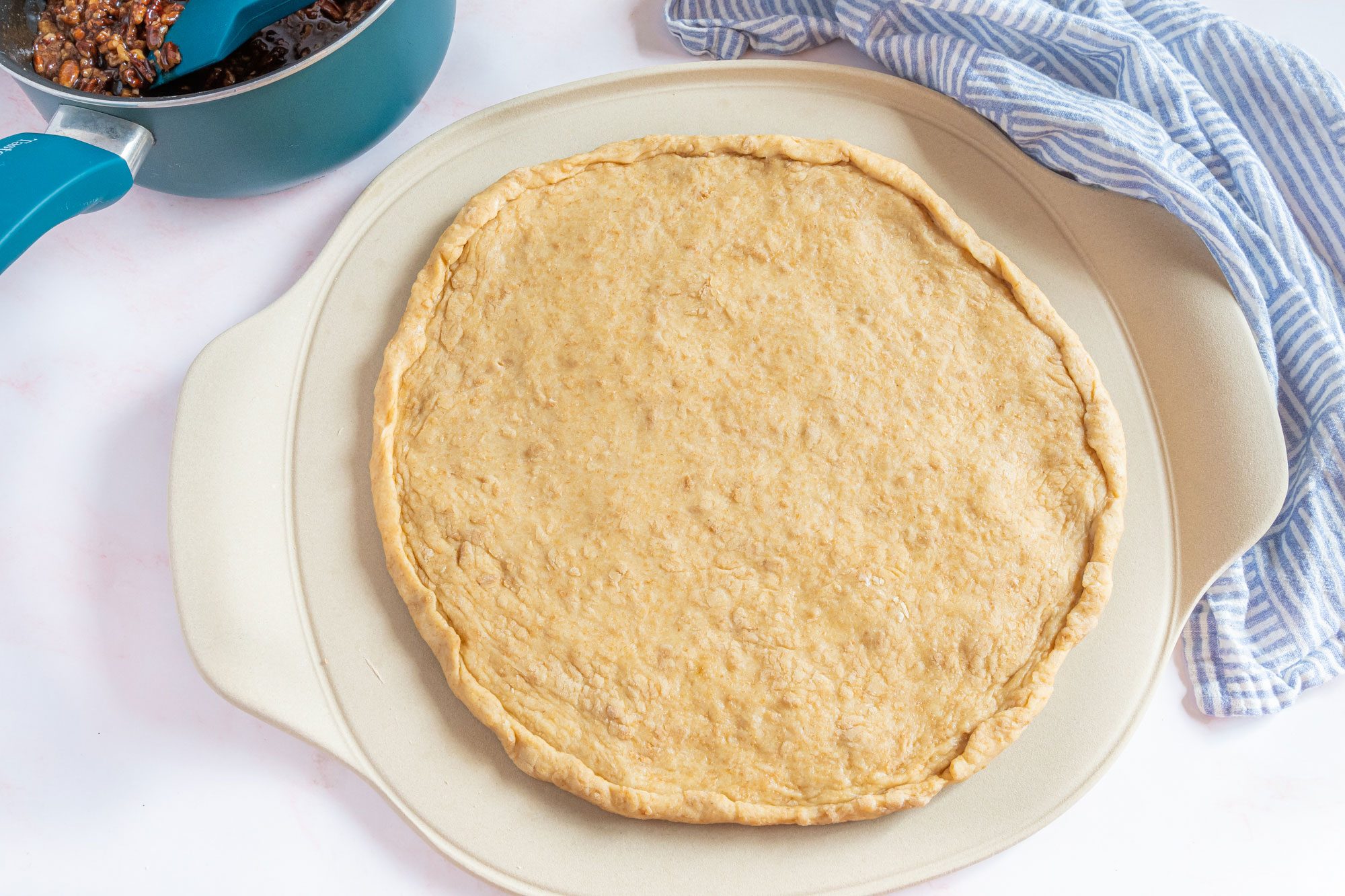 Pecan Pizza Coffee Cake dough pressed out into a round shape