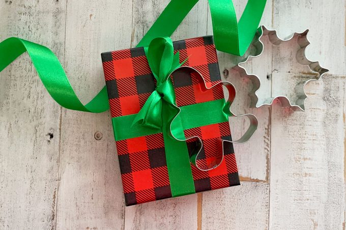christmas gift wrapped with a cookie cutter attached with a ribbon