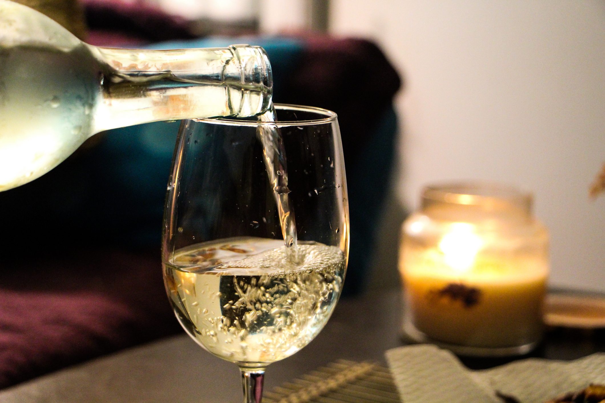 Cropped Image Of Bottle Pouring White Wine into Glass
