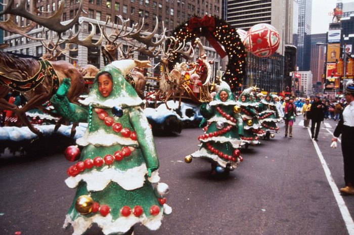 Several children dressed as Christmas trees wave at the 69th Macy's Thanksgiving Day Parade November 23, 1995 in New York City.