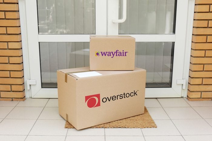 Wayfair and Overstock packages near a front door