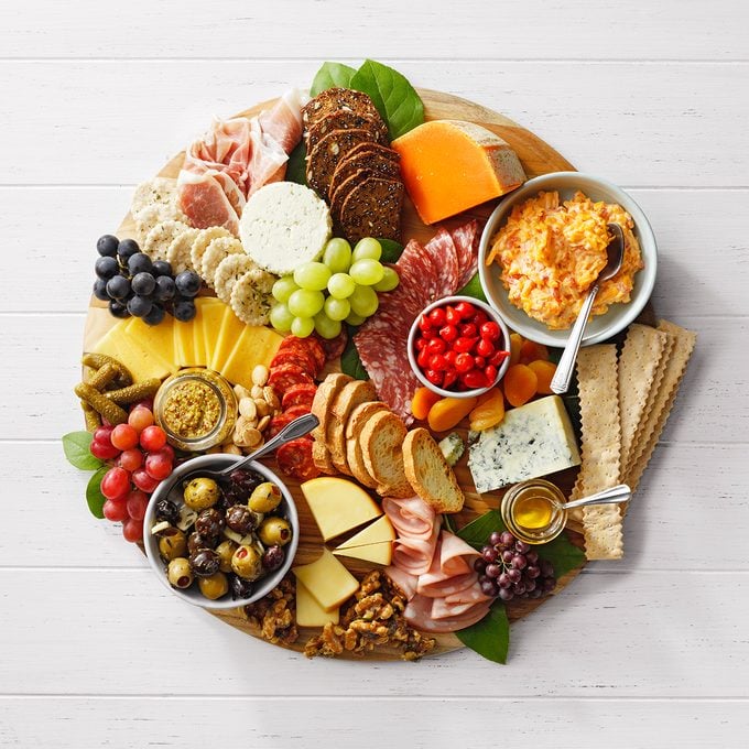 adding nuts and finishing touches to charcuterie board