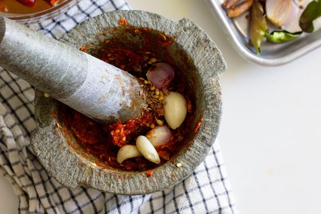 making Khao Soi Paste in mortar and pestle