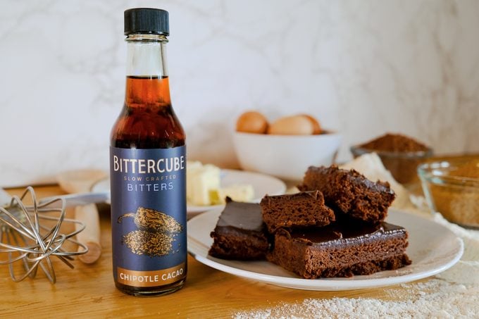 bottle of bittercube chipotle cacao bitters next to baked brownies on a plate