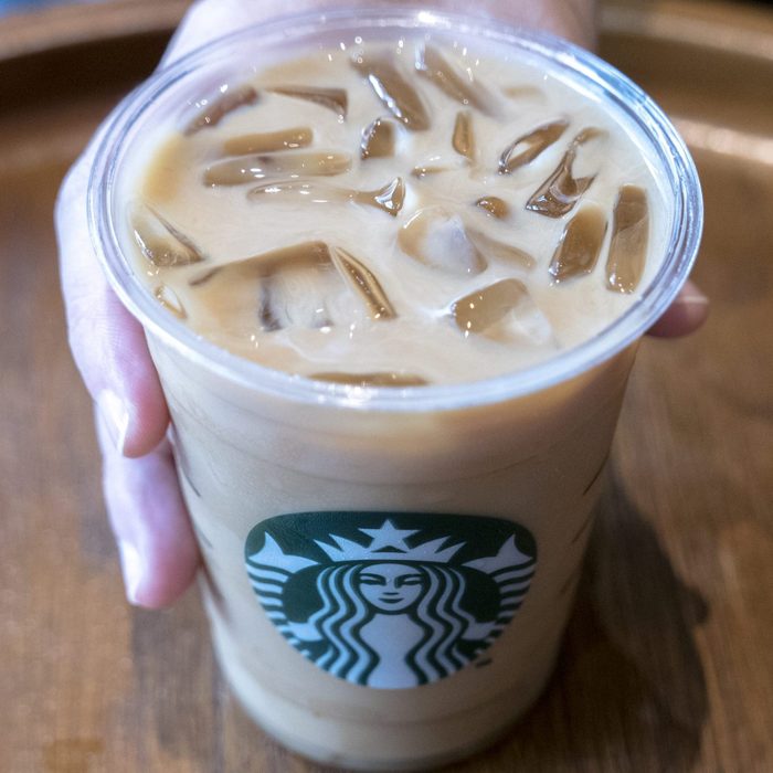 A cup of icy Starbuck coffee. Logo on a cup of Starbuck...