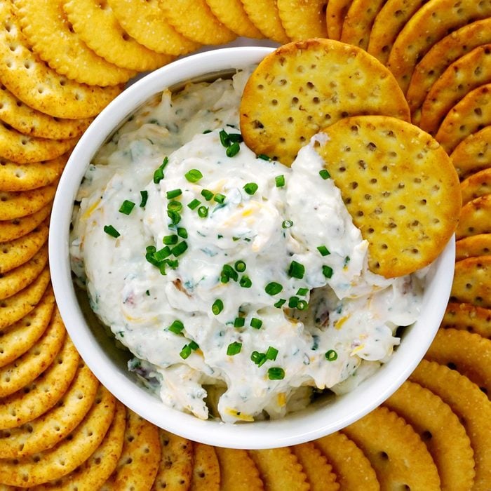 Loaded Hidden Valley Ranch Dip in a bowl surrounded by crackers