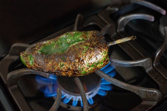 Roasting Poblano Chile over stove flame