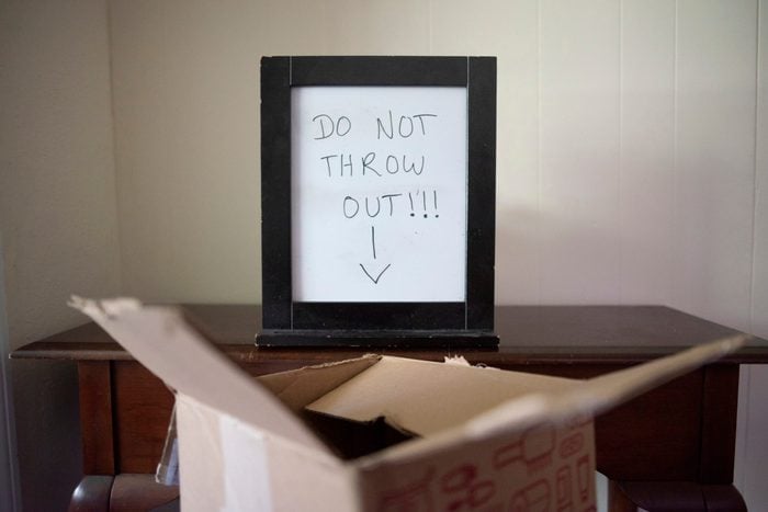 sign that reads "don't throw out" above box