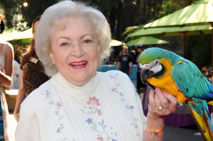 betty white holding a parrot at the los angeles zoo