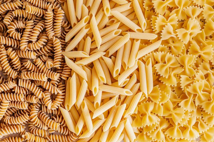 Overhead view of wholegrain fusilli, penne and farfalle pasta