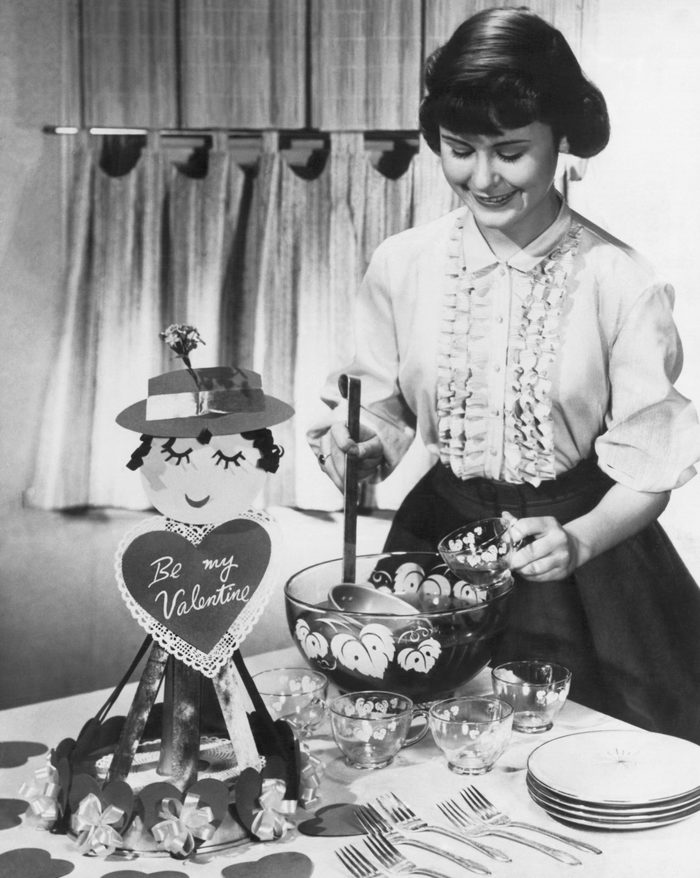 A young woman teenager serves punch at a Valentine's Day party, February 14, 1957. (Photo by Underwood Archives/Getty Images)