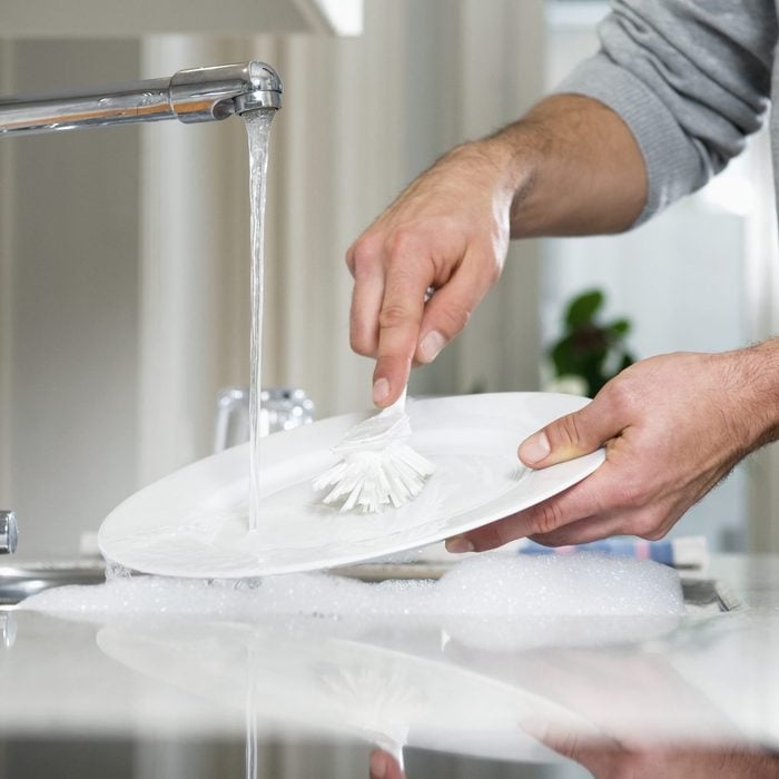 Man cleaning plate