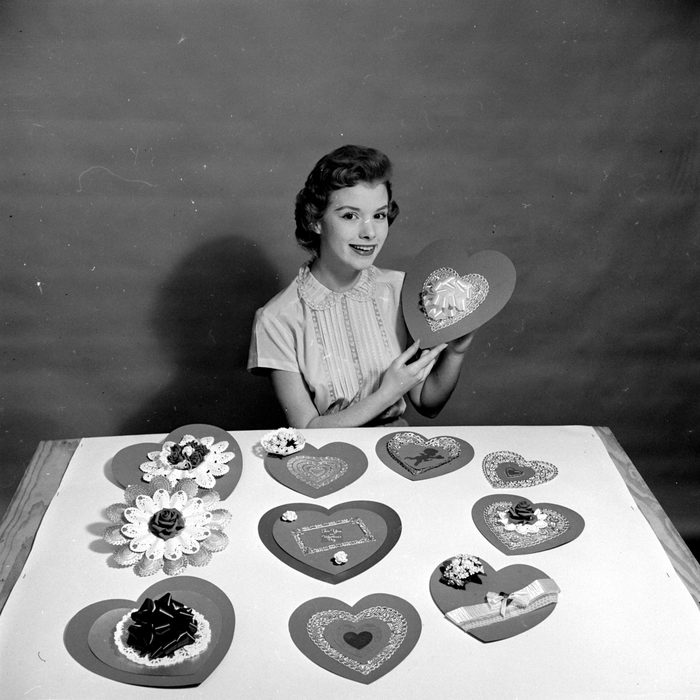 A woman making heart-shaped home-made cards for her sweethearts on Saint Valentine's Day. 