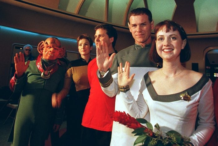 Joined by Ferengis, Klingons and Starfleet crew members, Star Trek fans Mikel (R) and Craig Salsgiver (2nd R) display the Vulcan greeting after renewing their vows on Valentine's Day - their fifth wedding annversary - on the bridge of the Starship Enterprise 14 February at "STAR TREK: The Experience" attraction at the Las Vegas Hilton. 