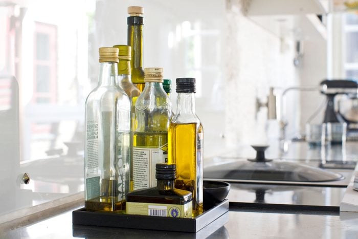 collection of different kinds of olive oils on a kitchen counter