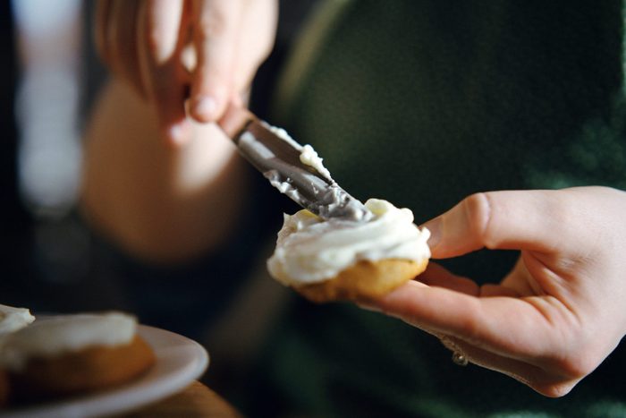 Woman Frosting Cookie