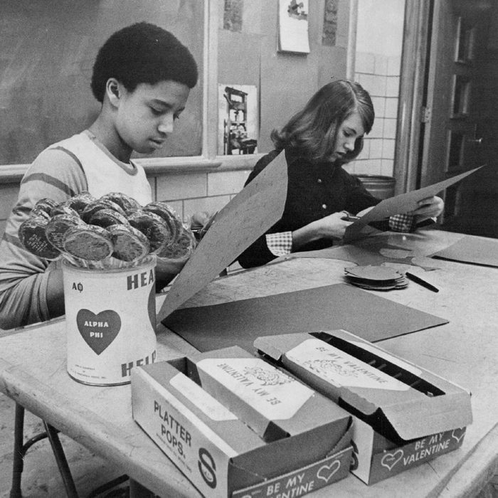 Lollipops will become Valentine gifts at Merrill Junior High when Darrell Cannon, eight-grade boy president, and Katie Russell, head girl, finish cutting hearts.