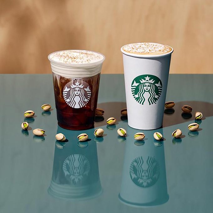 Starbucks Winter Promo Items surrounded by pistachios on a green reflective table