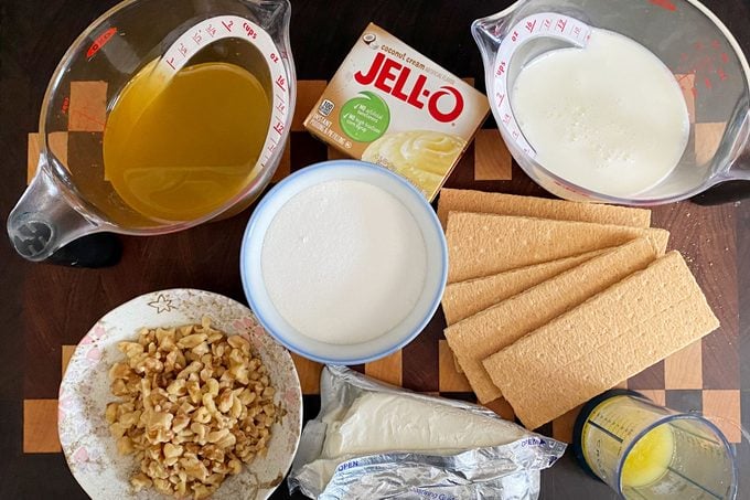 Creamy Pineapple Squares ingredients laid out on a wood cutting board surface