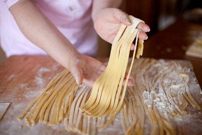 Hands of woman sorting some noodles