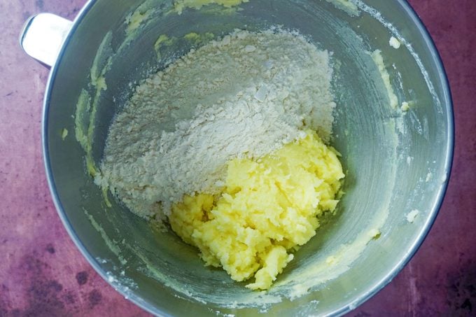 ingredients in a mixer bowl on a purple background