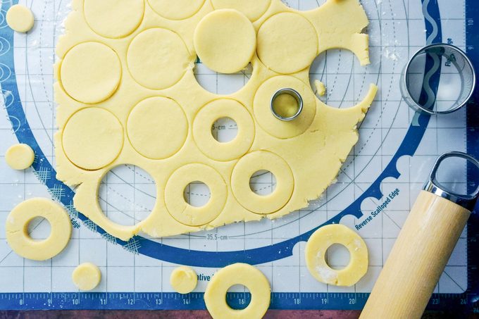 rolled out dough being cut into circles